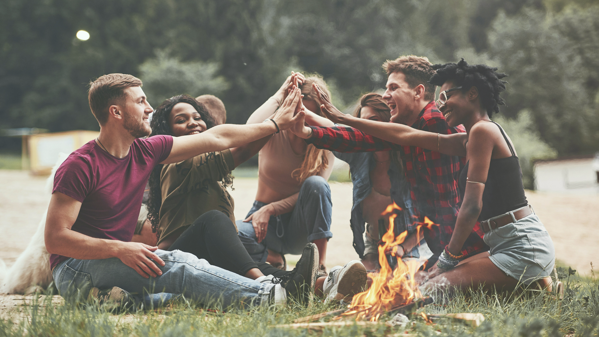 A group of people sharing and celebrating around the fire